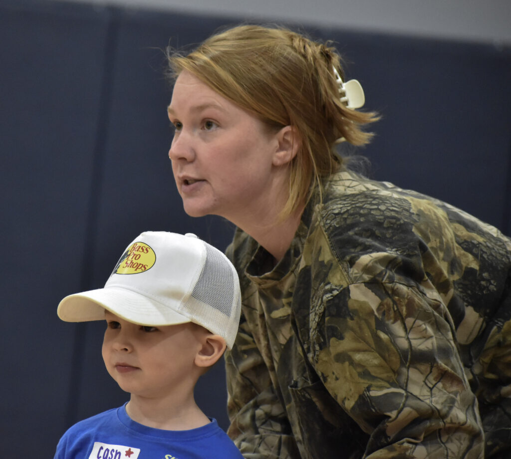 A child and his mother looking to the left.