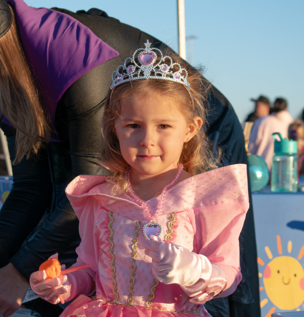 A child dressed in a princess costume, looking at the camera.