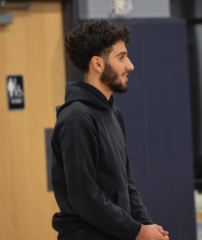 Man smiling while looking to the right.